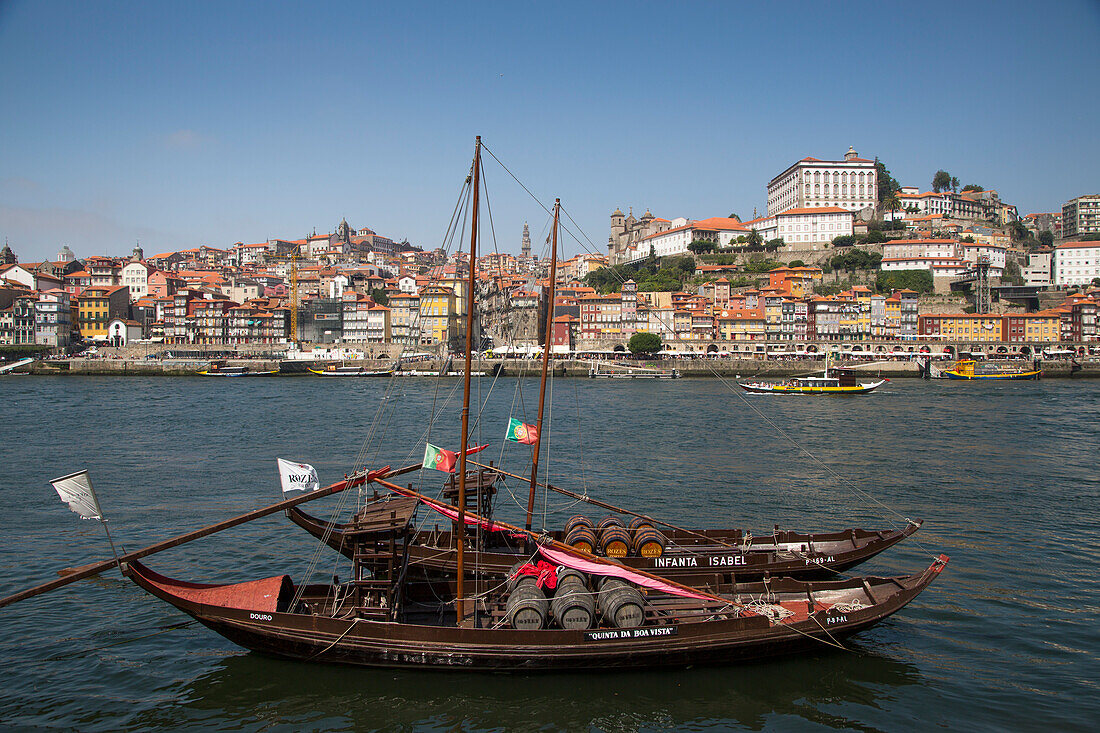 Traditional port wine transport boats on Douro river with view of Ribeira old town and historical center, Vila Nova de Gaia, Porto, Norte, Portugal