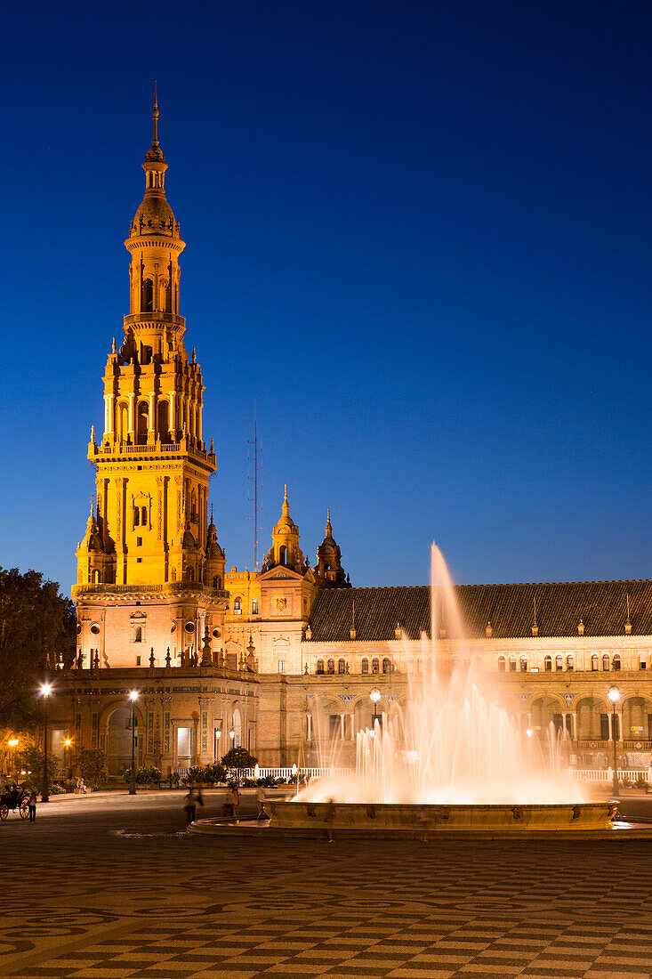 Illuminated fountain at Plaza de Espana in Maria Luisa Park at dusk, Seville, Andalusia, Spain