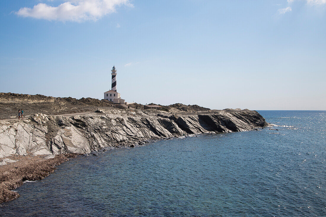 Rocky coastline and Cap de Favaritx lighthouse, Cap de Favaritx, Menorca, Balearic Islands, Spain