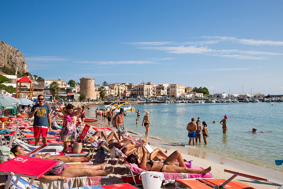 People relax at Mondello beach on a sunny Sunday morning, Mondello, near Palermo, Sicily, Italy