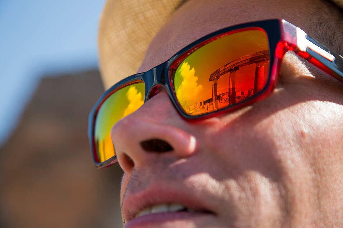 Reflection of ancient Roman ruins in colorful sunglasses, Pompeii, Campania, Italy