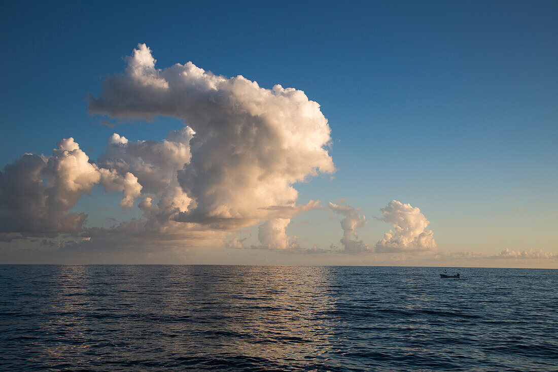 Fishing boat and white cumulus cloud over Mediterranean Sea, Alanya, Antalya, Turkey