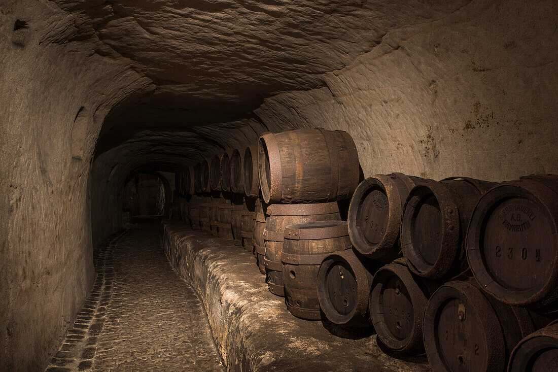 Historic barrels on display in Katakomben catacomb tunnel system of Bayreuther Bierbrauerei AG, Bayreuth, Franconia, Bavaria, Germany