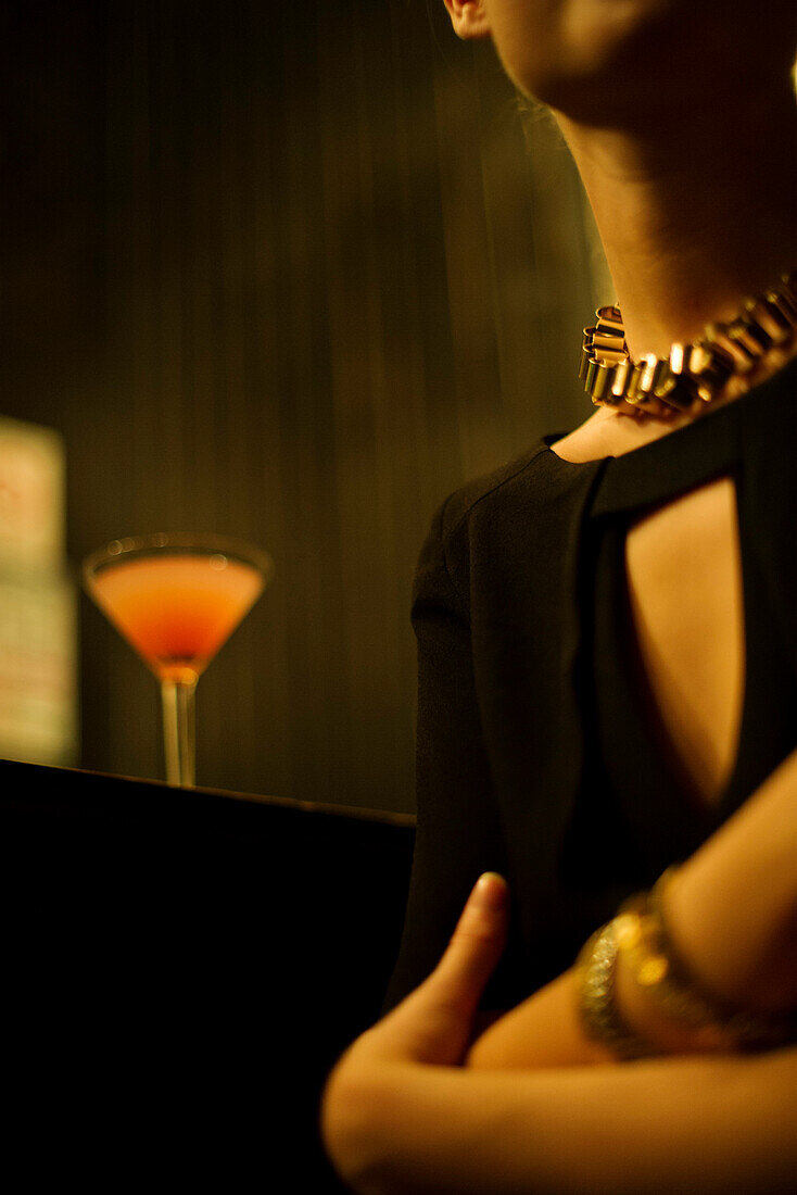 Woman sitting alone at night club bar