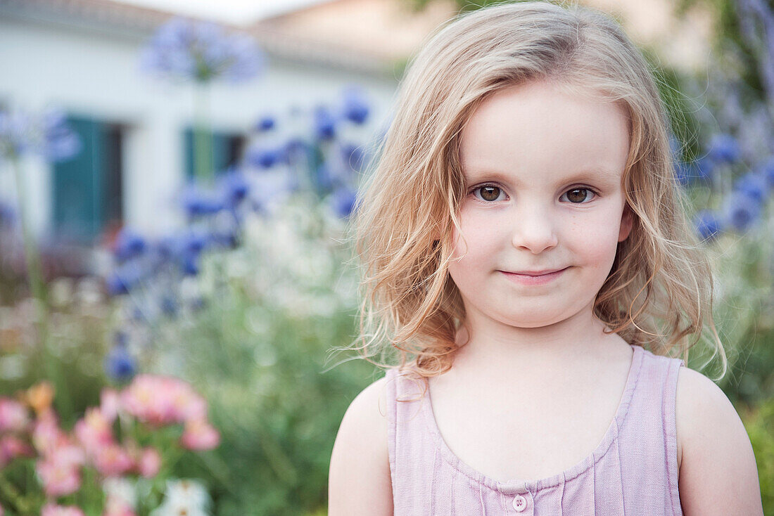 Little girl smiling outdoors, portrait