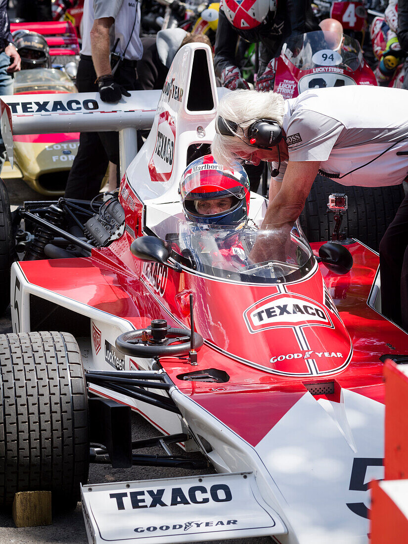 Emerson Fittipaldi strapped into his car, 1974 McLaren-Cosworth M23 Formula 1 racing car, Goodwood Festival of Speed 2014, racing, car racing, classic car, Chichester, Sussex, United Kingdom, Great Britain