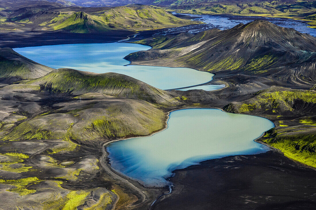 Aerial view of two lakes being fed by glacial river Tungnaa, high-voltage powerline between them, Veidivotn, Highlands, South Iceland, Iceland, Europe