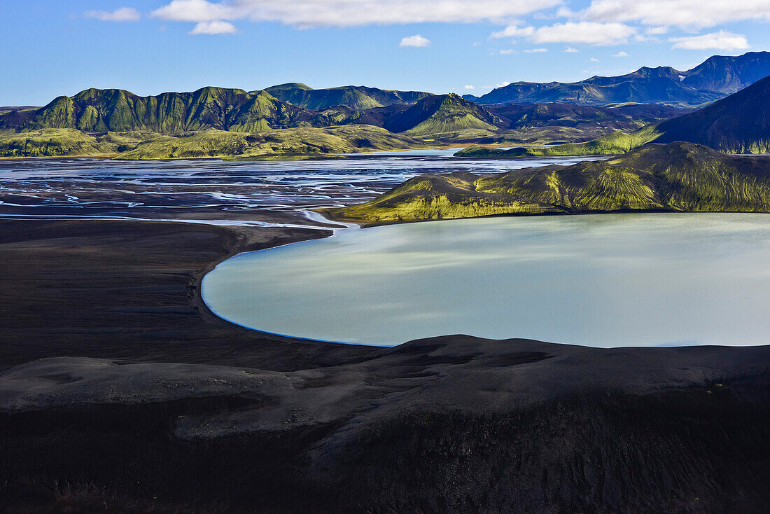 Aerial view of crater lake meeting the meanders of  glacial river Tungnaa, Veidivotn, Highlands, South Iceland, Iceland, Europe