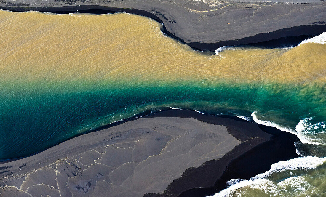 Aerial view of her bicolored glacial river Thjorsa floating into Atlantic Ocean near Thykkvibaer, South Iceland, Iceland, Europe
