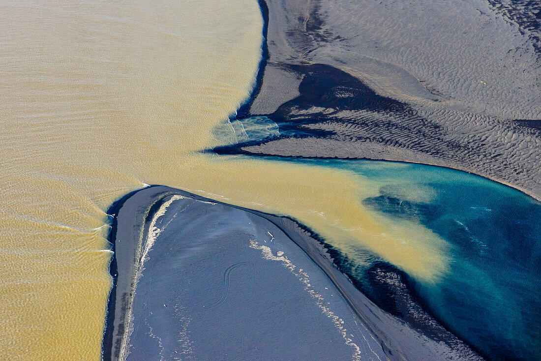 Aerial view of her bicolored glacial river Thjorsa floating into Atlantic Ocean near Thykkvibaer, South Iceland, Iceland, Europe
