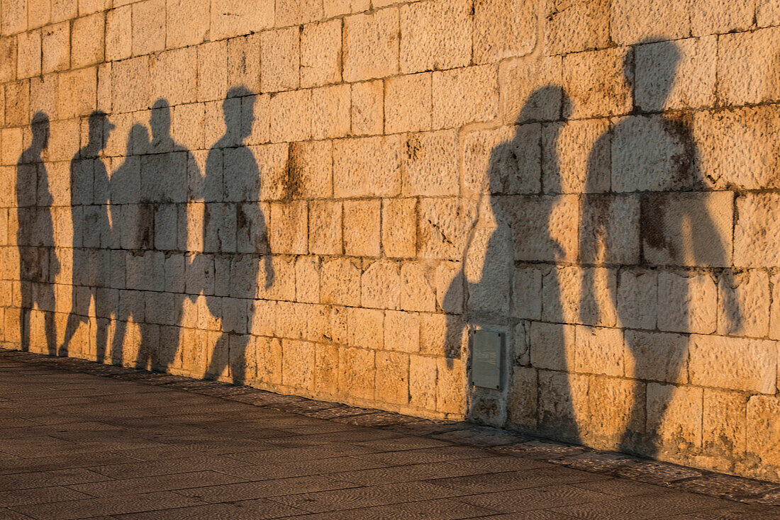 Shadow of people on stone wall, Hvar, Dalmatia, Croatia