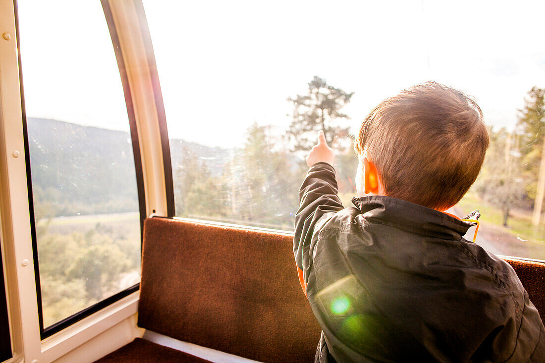Caucasian boy looking out tram window, Napa, California, United States