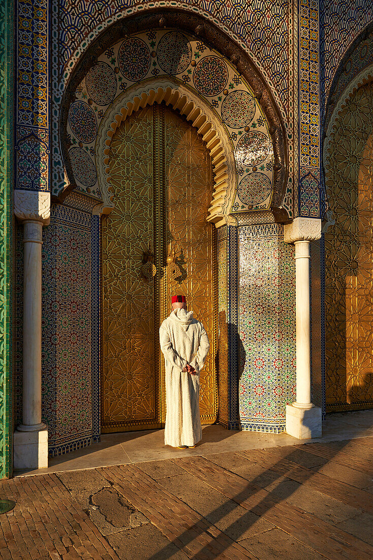 Caucasian man standing by ornate temple, Fes, Fes-Boulemane, Morocco