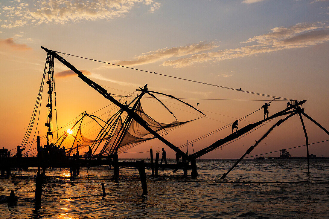 Silhouette of fishing nets at sunset, Cochin, Kerala, India