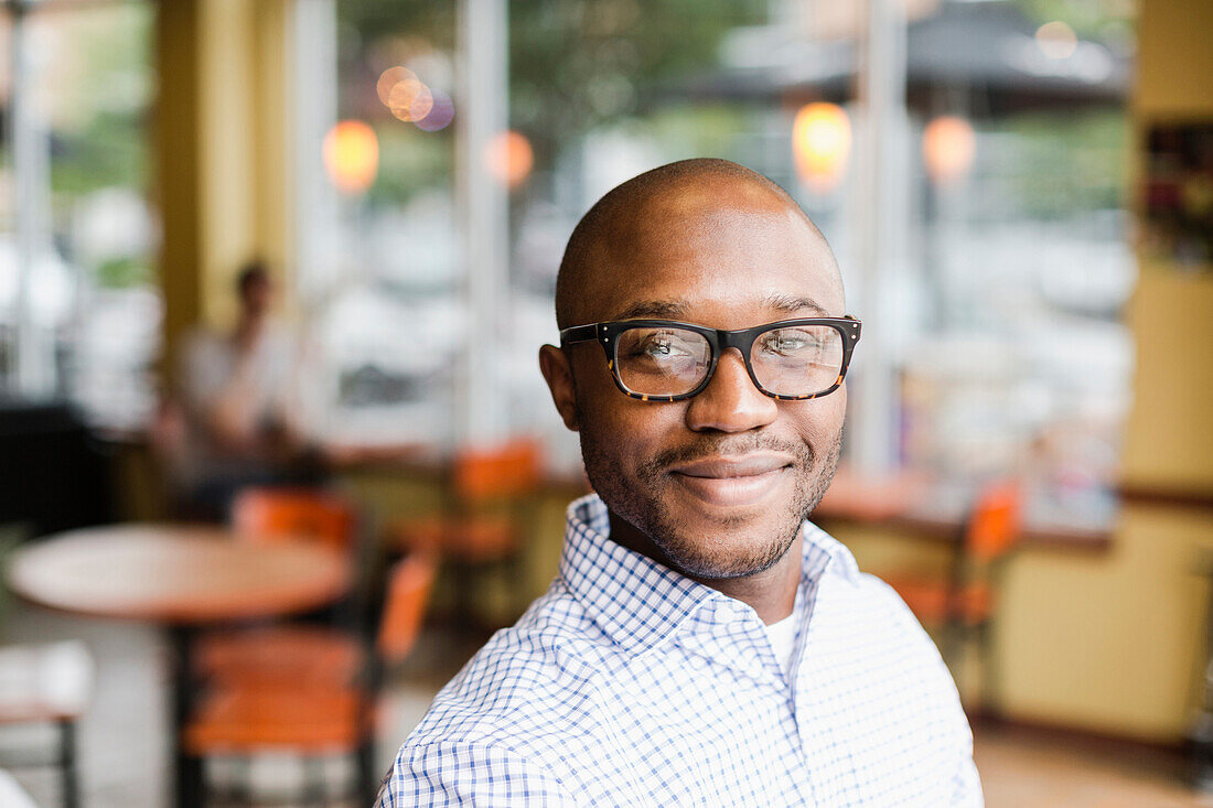 Black man smiling in coffee shop, Norfolk, Virginia, USA