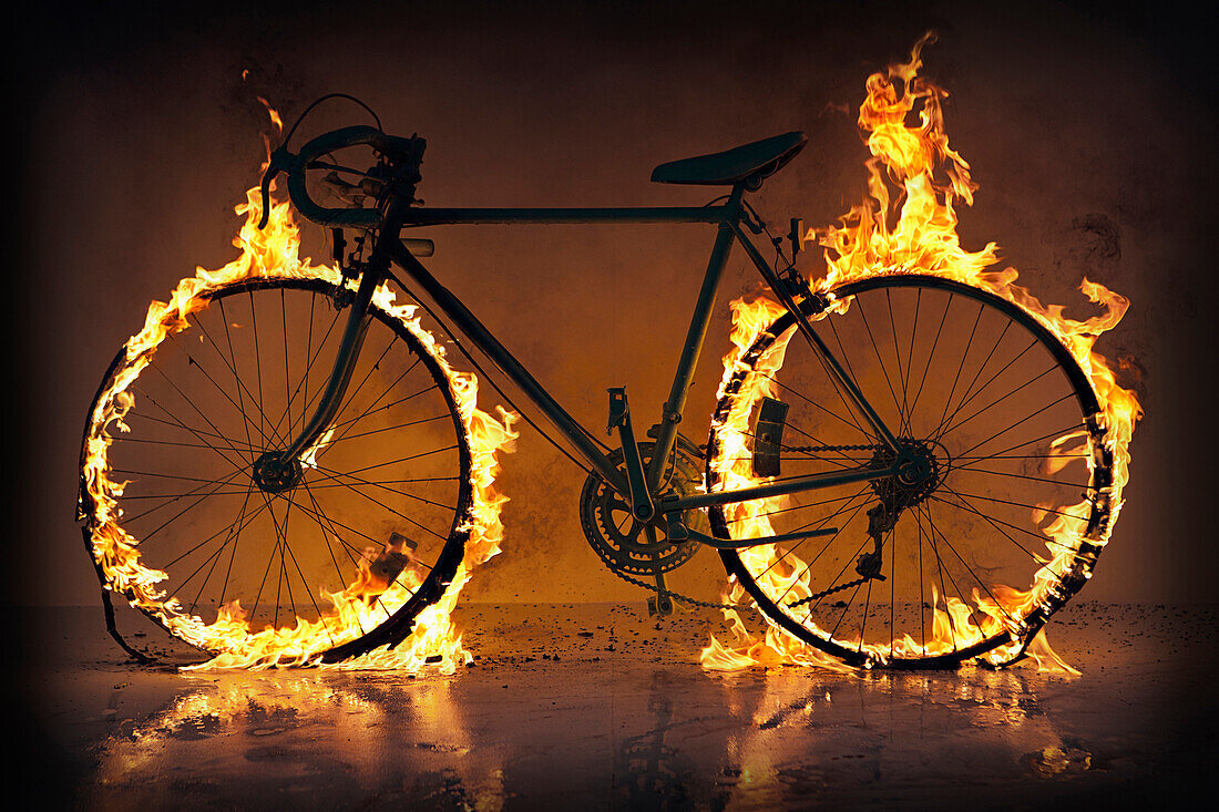 Silhouette of bicycle with flaming tires, Austin, Texas, USA