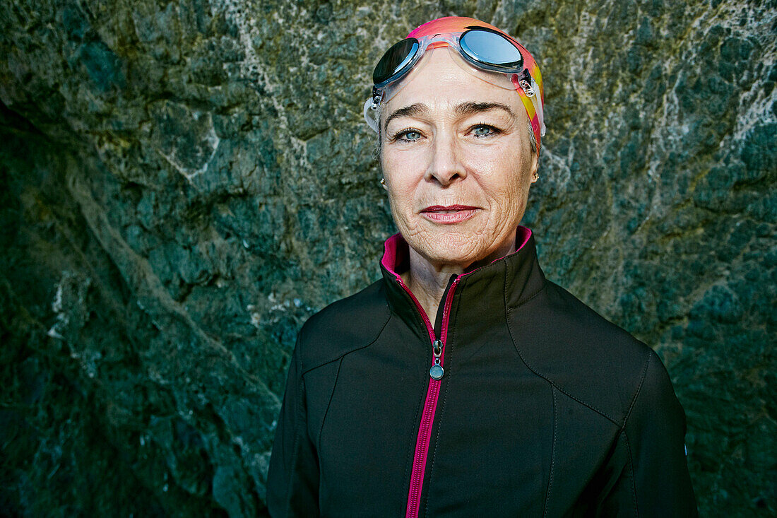 Older Caucasian woman wearing goggles near rock, Los Angeles, California, USA