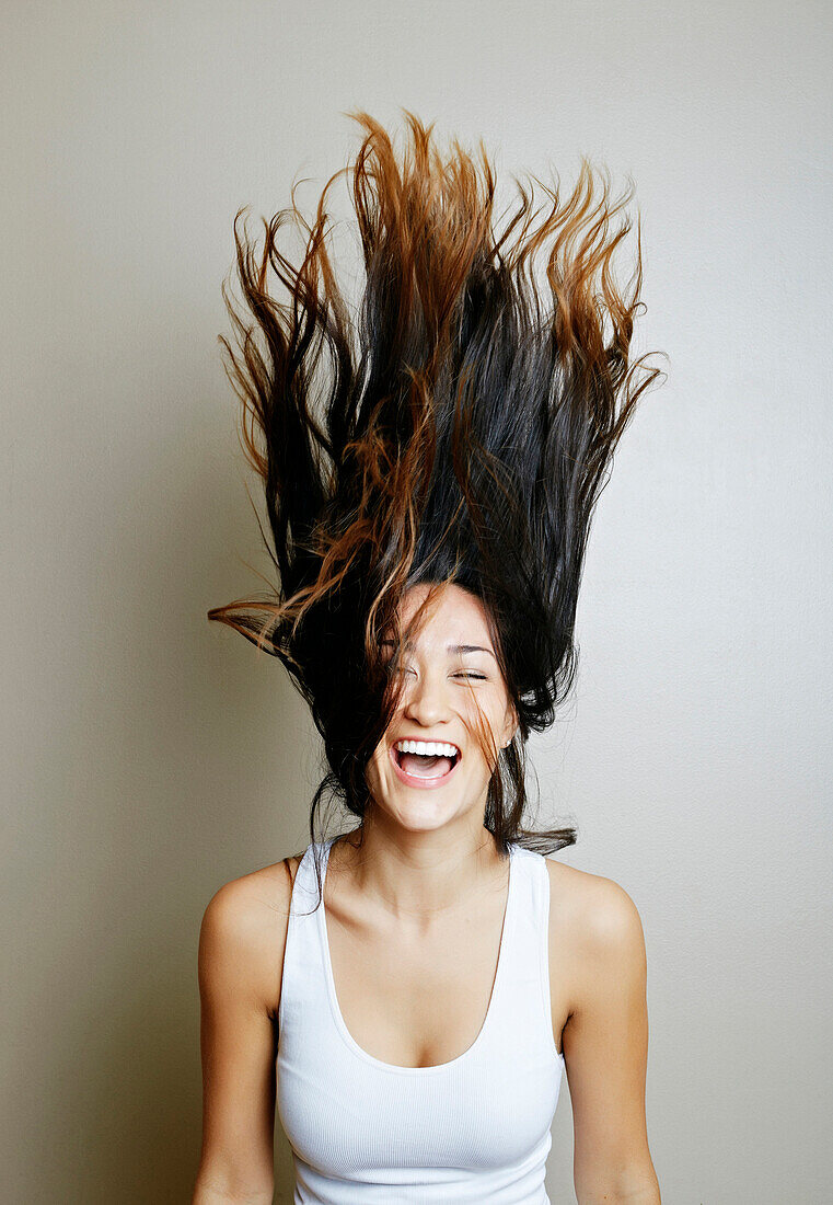 Mixed race woman tossing her hair, Los Angeles, California, USA