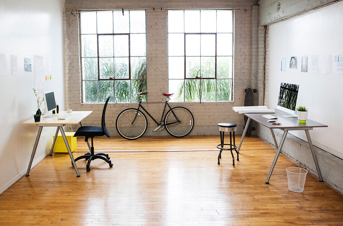 Bicycle and desks in modern office, Los Angeles, California, USA