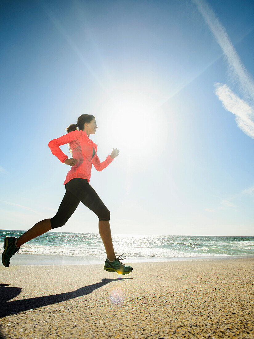 Caucasian woman running on beach, Laguna Beach, California, USA