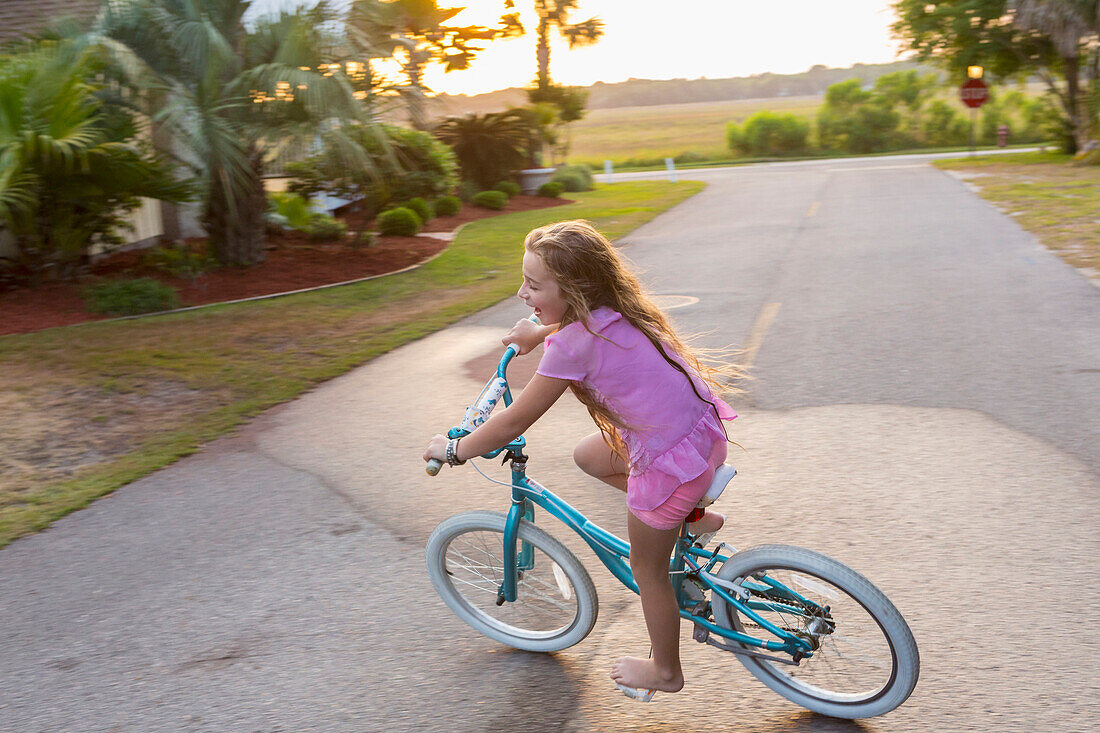 Caucasian girl riding bicycle on street, Brunswick, Georgia, USA