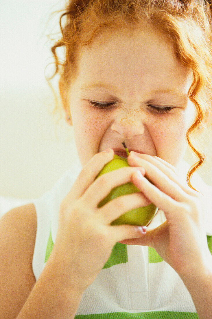 Girl eating apple, Miami, FL, USA