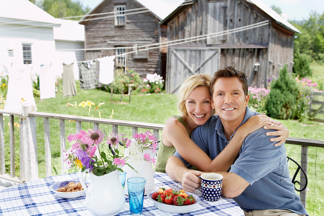 Couple having coffee on patio, Denver, New York, USA