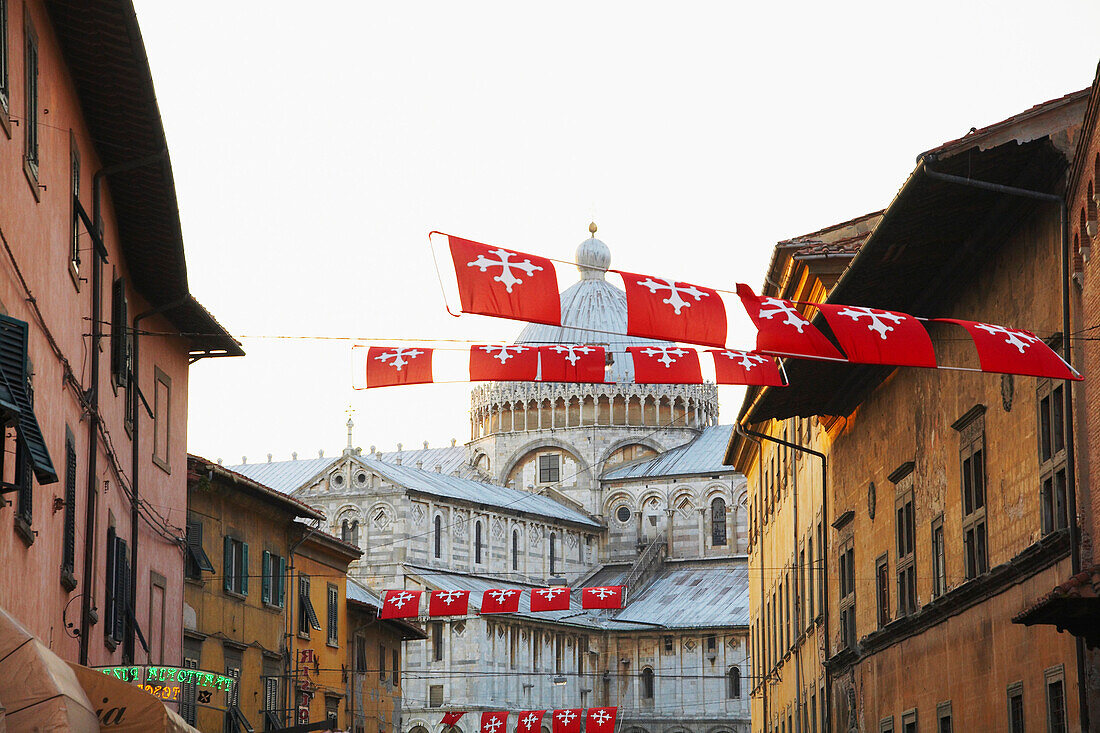 Flags flying over city street, Pisa, Toscano, Italy, , Pisa, Toscano, Italy