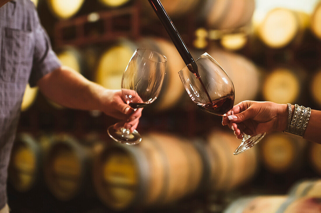 Caucasian couple tasting wine in cellar, Walla Walla, WA, USA