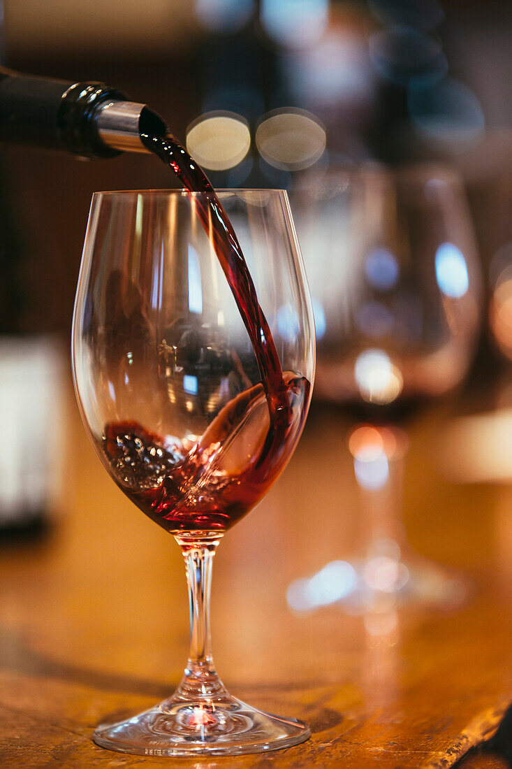 Close up of wine pouring into glass on table, , Walla Walla, WA, USA