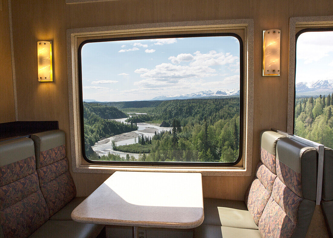 River in rural landscape viewed from train window, Anchorage, Denali National Park Park, USA