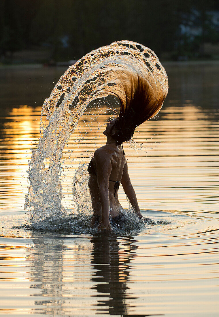 Korean woman flipping hair in lake, C1