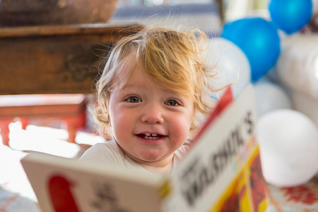 Caucasian baby boy playing with book, Santa Fe, New Mexico, USA