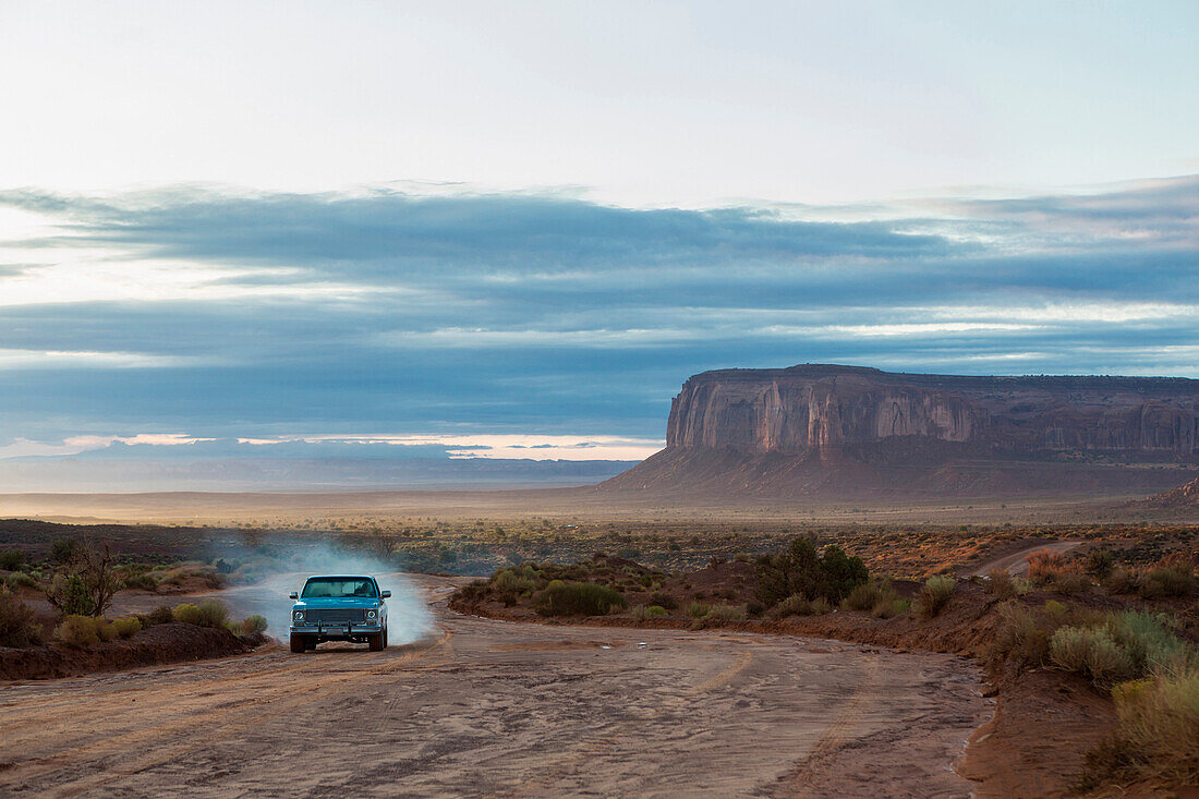 Car driving on dirt road in desert, Monument Valley, Utah, United States, Monument Valley, Utah, USA