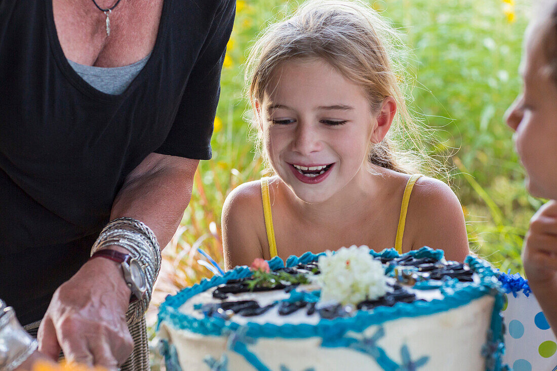 Family celebrating birthday together outdoors, Santa Fe, New Mexico, USA