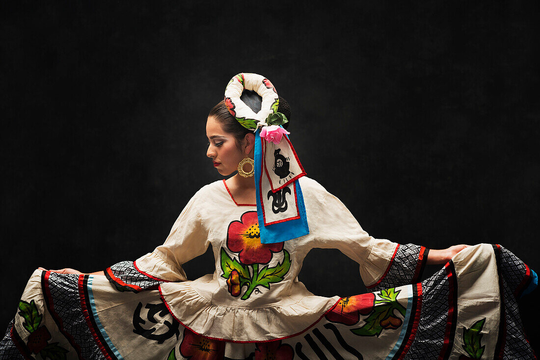 Hispanic teenage girl dancing in Sinaloa Folkloric dress, Petaluma, California, United States