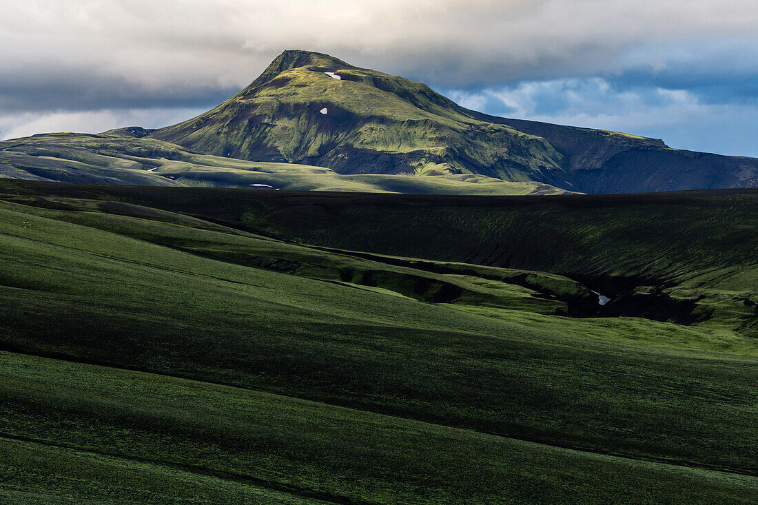 Mountain over rolling hills in rural landscape, Blafejall, Iceland, Iceland