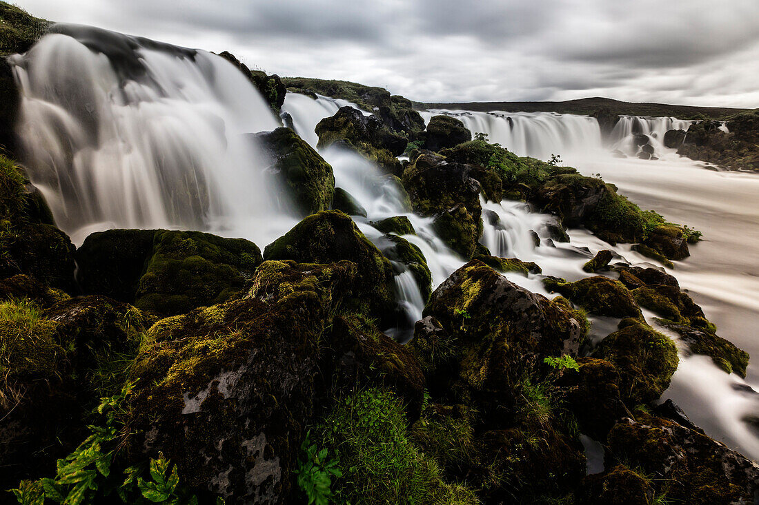 Waterfall pouring over rock formations in remote river, Southern Highlands, Iceland, Iceland