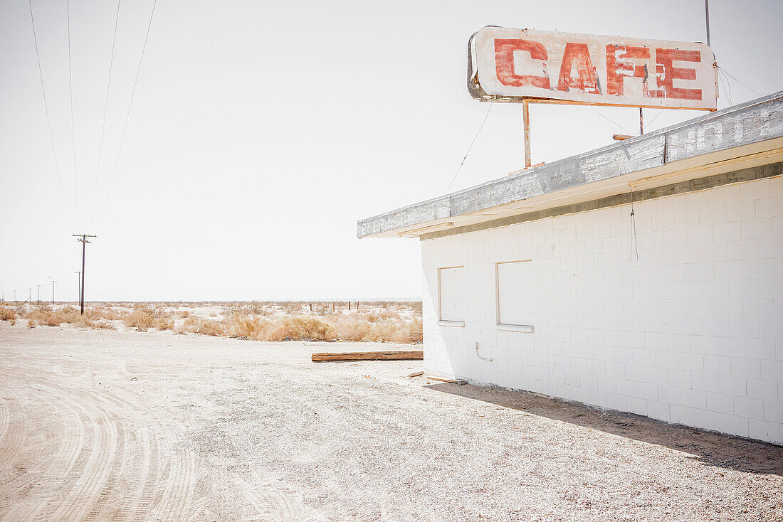 Abandoned cafe on rural dirt road, Bombay Beach, California, USA