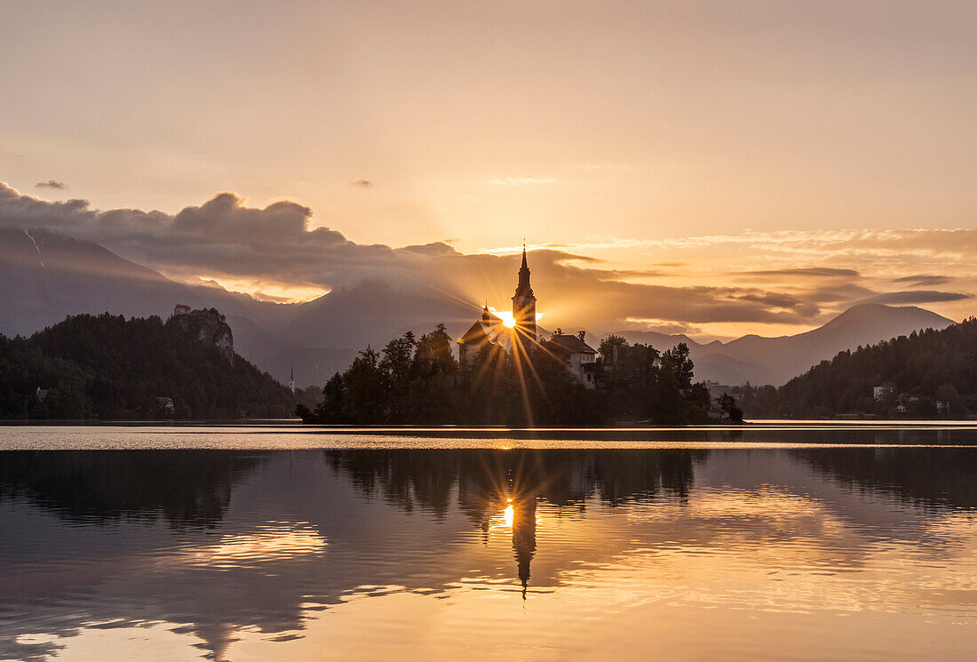 Sunrise over church tower reflected in still lake, Bled, Upper Carniola, Slovenia, Bled, Upper Carniola, Slovenia