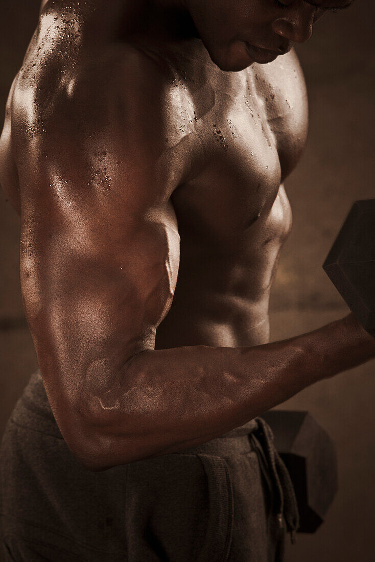 African American man lifting weights, Saint Louis, MO, USA