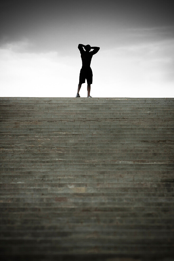 Black man stopping at top of stairs, Saint Louis, MO, USA