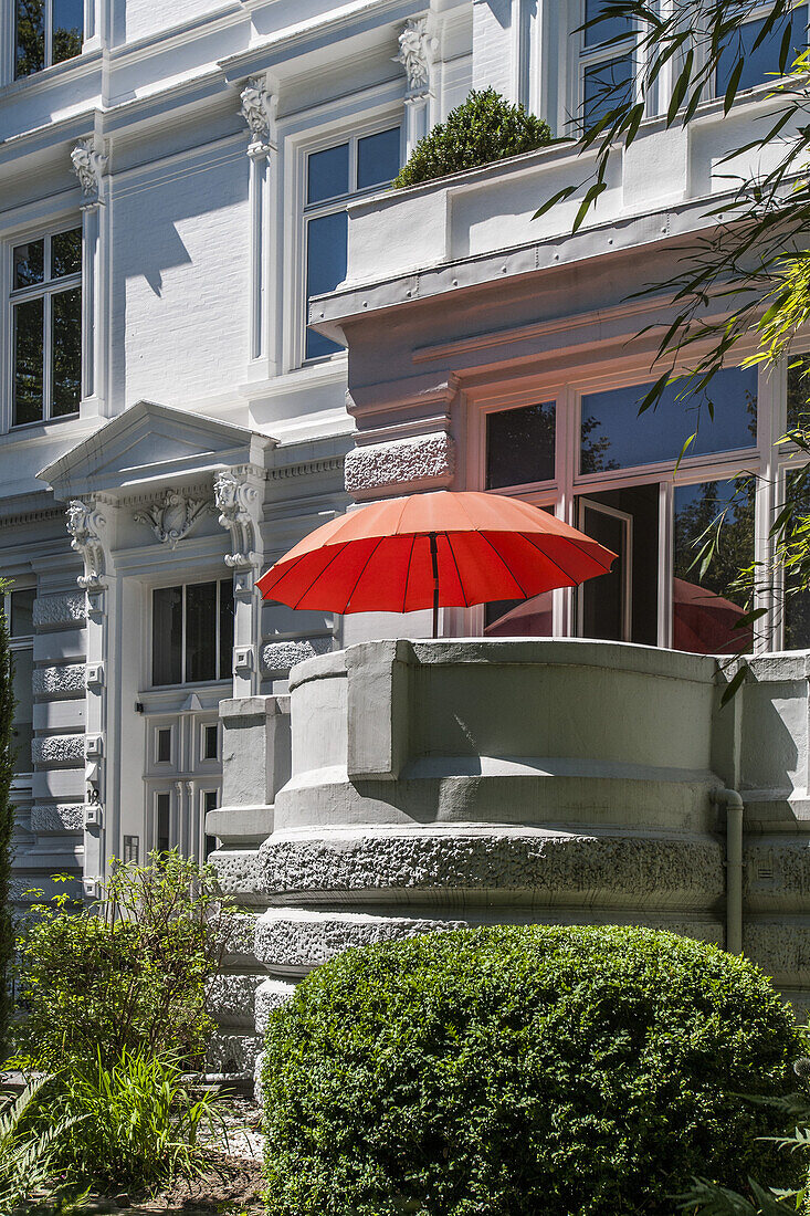 Modern red parasol on the balcony of an art nouveau house in Hamburg, Hamburg, Germany