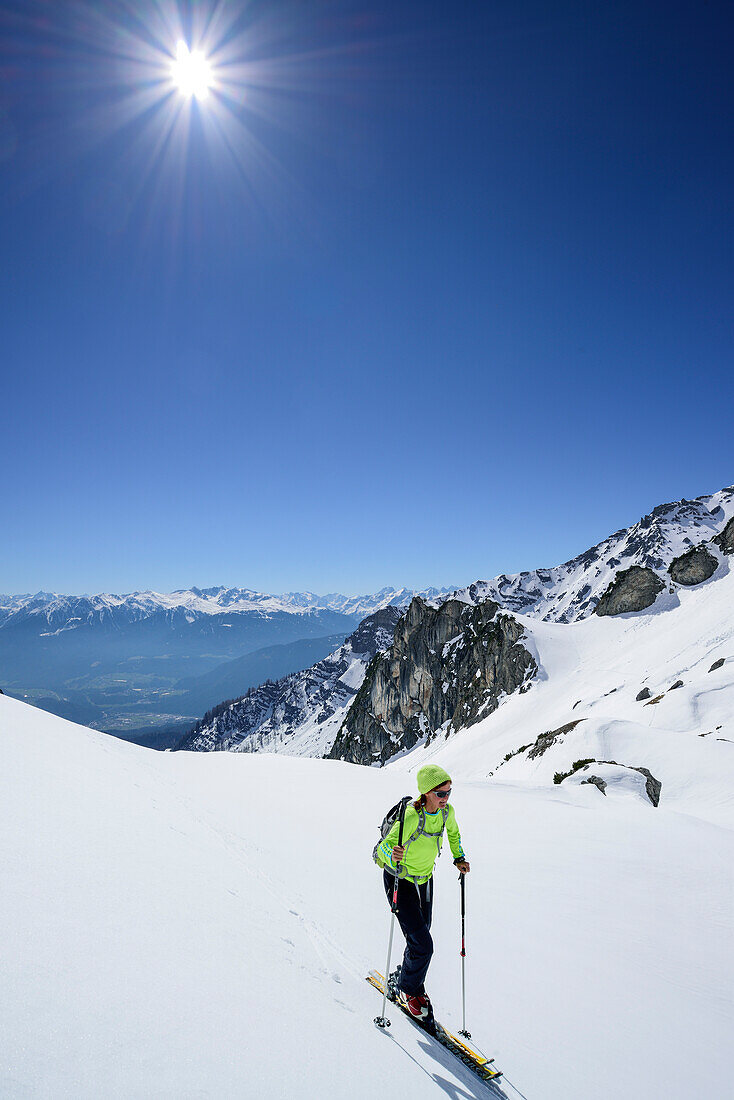 Woman back-country skiing ascending towards Scharnitzsattel, Scharnitzsattel, Lechtal Alps, Tyrol, Austria