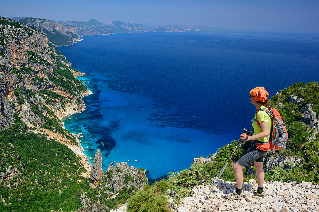 Woman standing at Punta Salinas and looking towards Cala Goloritze at Mediterranean, Punta Salinas, Selvaggio Blu, National Park of the Bay of Orosei and Gennargentu, Sardinia, Italy