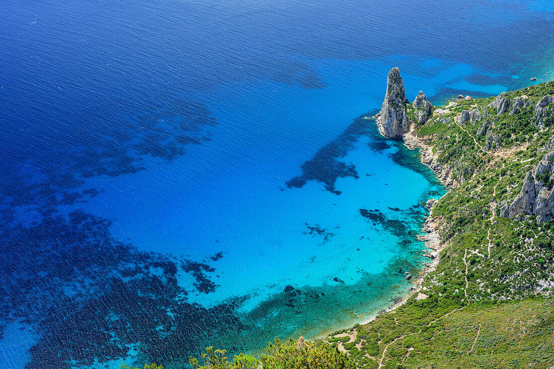 View from Punta Giradili at coast of Golfo di Orosei with rock spire Pedra Longa, Selvaggio Blu, National Park of the Bay of Orosei and Gennargentu, Sardinia, Italy