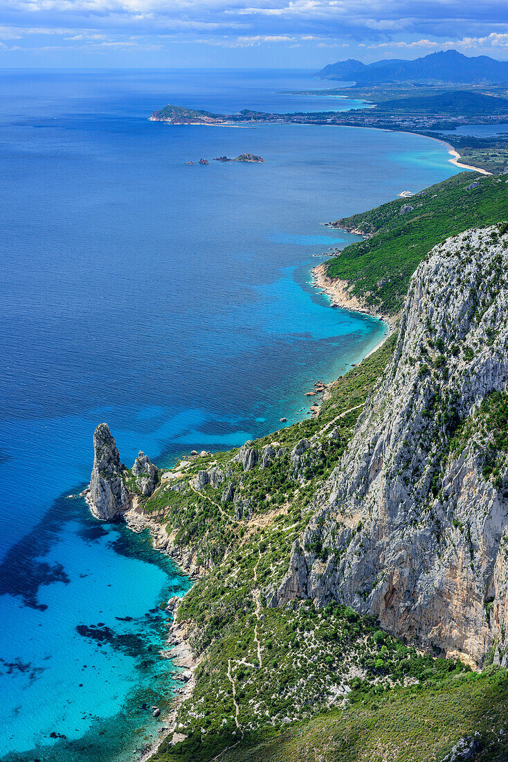 View from Punta Giradili at coast of Golfo di Orosei with rock spire Pedra Longa, Selvaggio Blu, National Park of the Bay of Orosei and Gennargentu, Sardinia, Italy