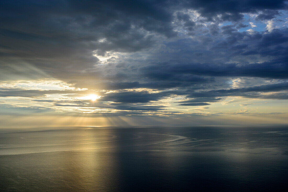 Sun shining through clouds on Mediterranean, National Park of the Bay of Orosei and Gennargentu, Sardinia, Italy