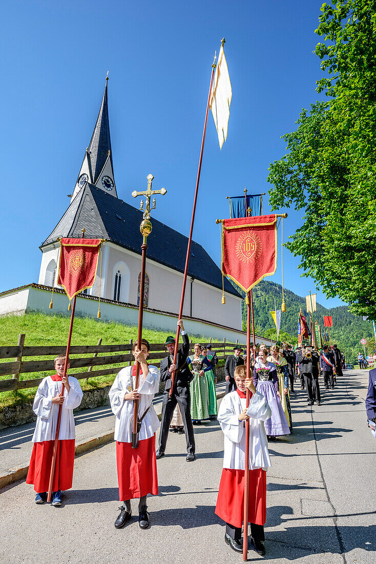 Procession during religious festival of Feast of Corpus Christi, church of Kreuth in background, Kreuth, Bavarian Alps, Upper Bavaria, Bavaria, Germany