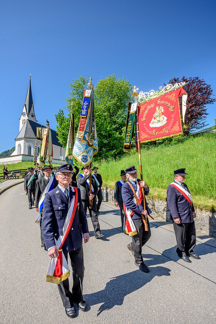 Procession during religious festival of Feast of Corpus Christi, church of Kreuth in background, Kreuth, Bavarian Alps, Upper Bavaria, Bavaria, Germany